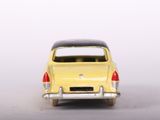 a yellow toy car that is sitting on a white surface