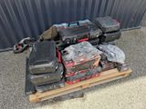 a pile of tools on a pallet in front of a building