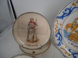 a plate with a picture of a man on it next to a plate with a picture of a man on it