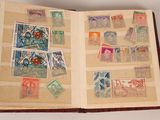 an open book with stamps on it on a table