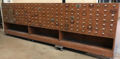 une grande armoire en bois comportant de nombreux tiroirs