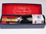 une bouteille de vin dans une boîte bleue munie d'une poignée dorée