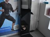 a picture of a woman standing in front of a gym machine