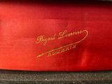 a close up of a red box with a gold logo on it