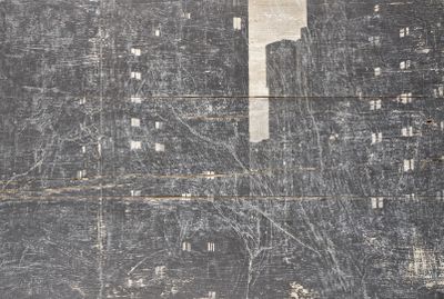 a black and white photo of a cityscape on a wooden wall