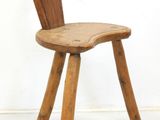 a wooden chair with a bent back and a wooden seat