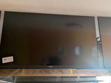 two flat screen televisions sitting on top of a shelf