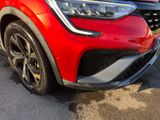 a close up of a red car parked in a parking lot