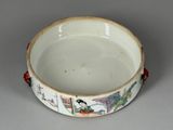 a white bowl with a bird on it on a table