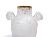 a white vase with a face on it on a white surface