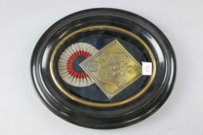 a picture of a gold plate with a fan on it
