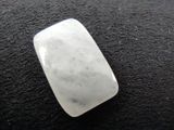 a picture of a white quartz stone on a black surface
