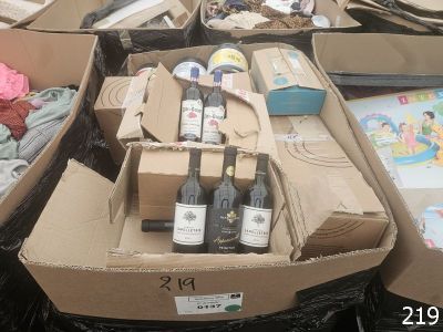 many boxes of wine and other items in the bins