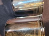 two silver salt and pepper shakers sitting on a table