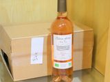 a bottle of wine sitting on a glass shelf next to a box