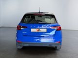 the rear end of a blue car parked in a garage