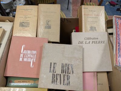 many books stacked on top of each other in a box