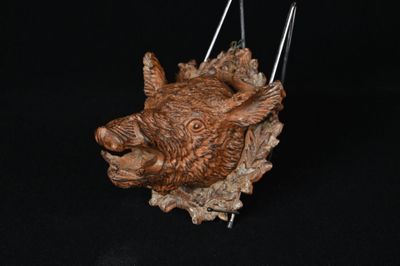 a sculpture of a boar head on a black background