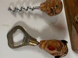 a bottle opener and a corkscue on a table