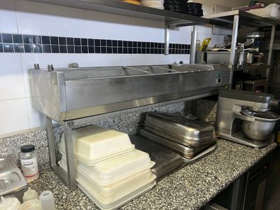a counter with a bunch of plates and pans on it