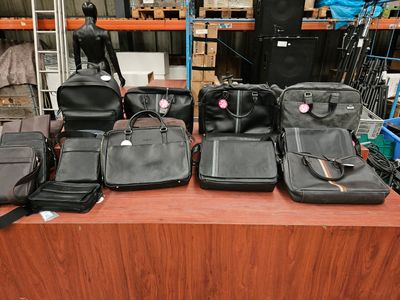 many pieces of luggage sitting on a table in a warehouse