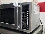 a microwave that is sitting on a shelf in a kitchen