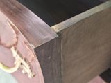 a drawer that has a wooden handle on it