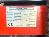 a close up of a red and black machine with a label on it