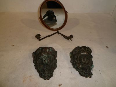 a mirror and a pair of lion heads on a table