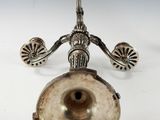 an antique silver plated candle holder on a white background