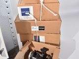 a pile of boxes and a laptop computer on a table
