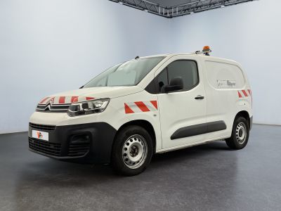 the white van is parked in a large room with a black floor