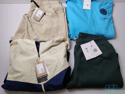 three pairs of men ' s pants and a t - shirt on a table