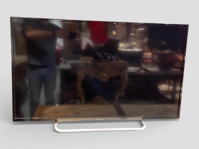 a man standing in front of a flat screen tv