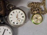 many different types of pocket watches on the table