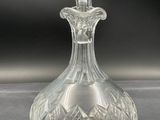 crystal decanter on a table with a black background