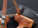 a leather bag with a gun inside of it