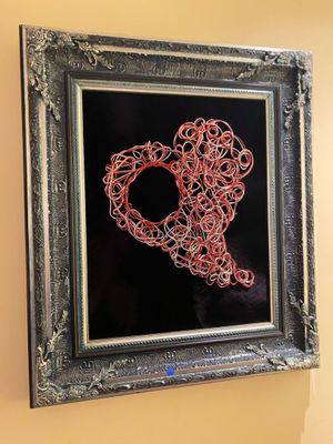 a picture of a picture of a heart made out of red string