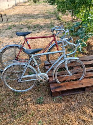 two bikes that are parked on a wooden pallet