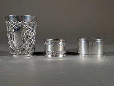 three silver cups sitting next to each other on top of a table