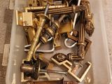 a plastic container filled with gold locks and keys