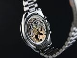 a close up of a wrist watch with a black background