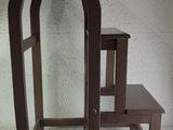 a small wooden chair and a small table on a white surface