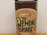 the demon ' s share coffee cup is sitting on a wooden table