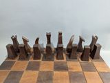 a wooden chess board with chess pieces on it