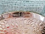 a silver plate with a name on it on a blue towel