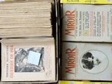 boxes of old books are stacked on top of each other on a table