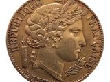 a close up of a gold coin with a woman ' s head