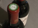 two bottles of wine that are sitting on a counter