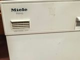 a white dishwasher sitting on top of a kitchen counter